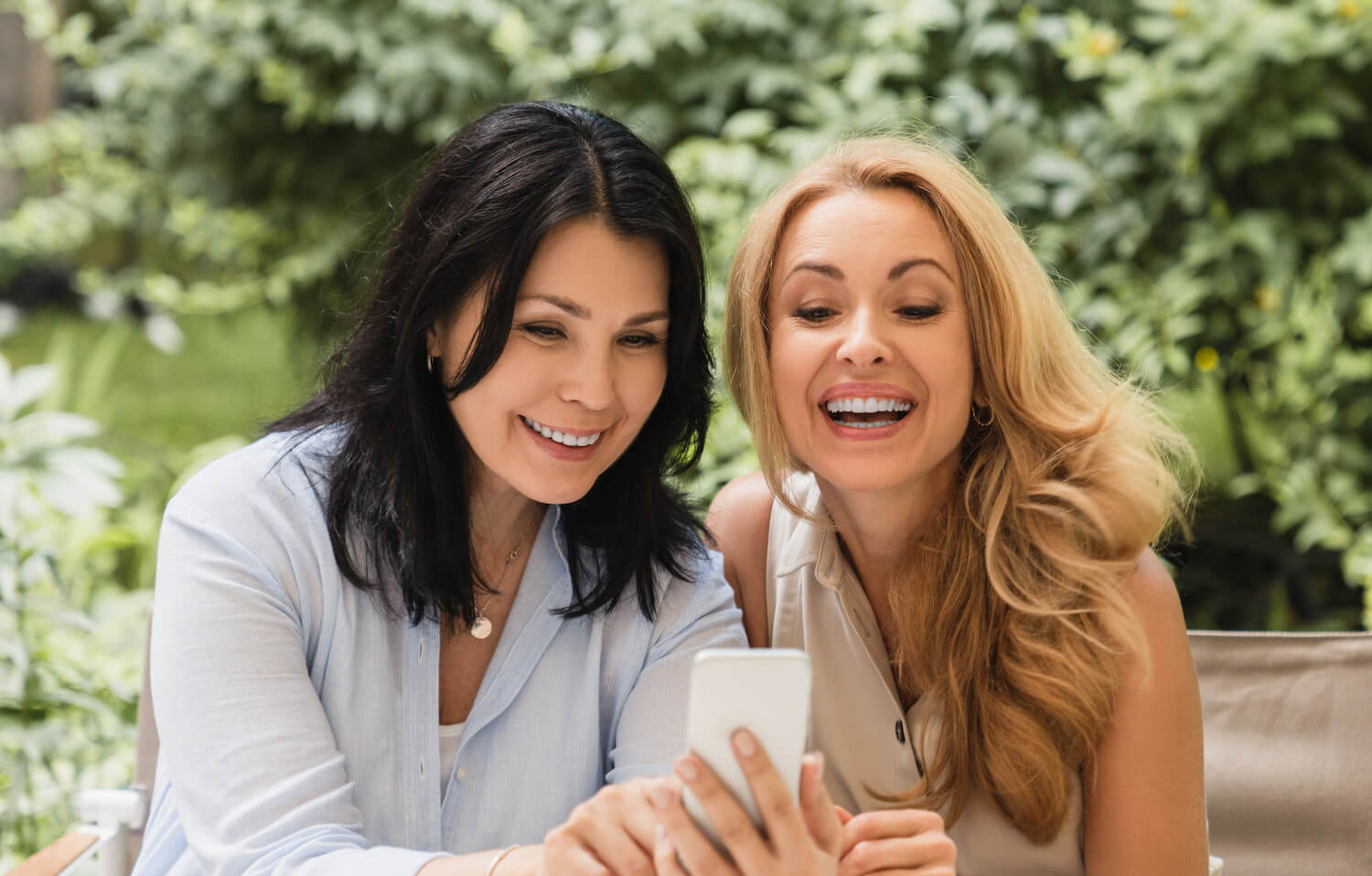 Cheerful smiling laughing two Caucasian middle-age women
